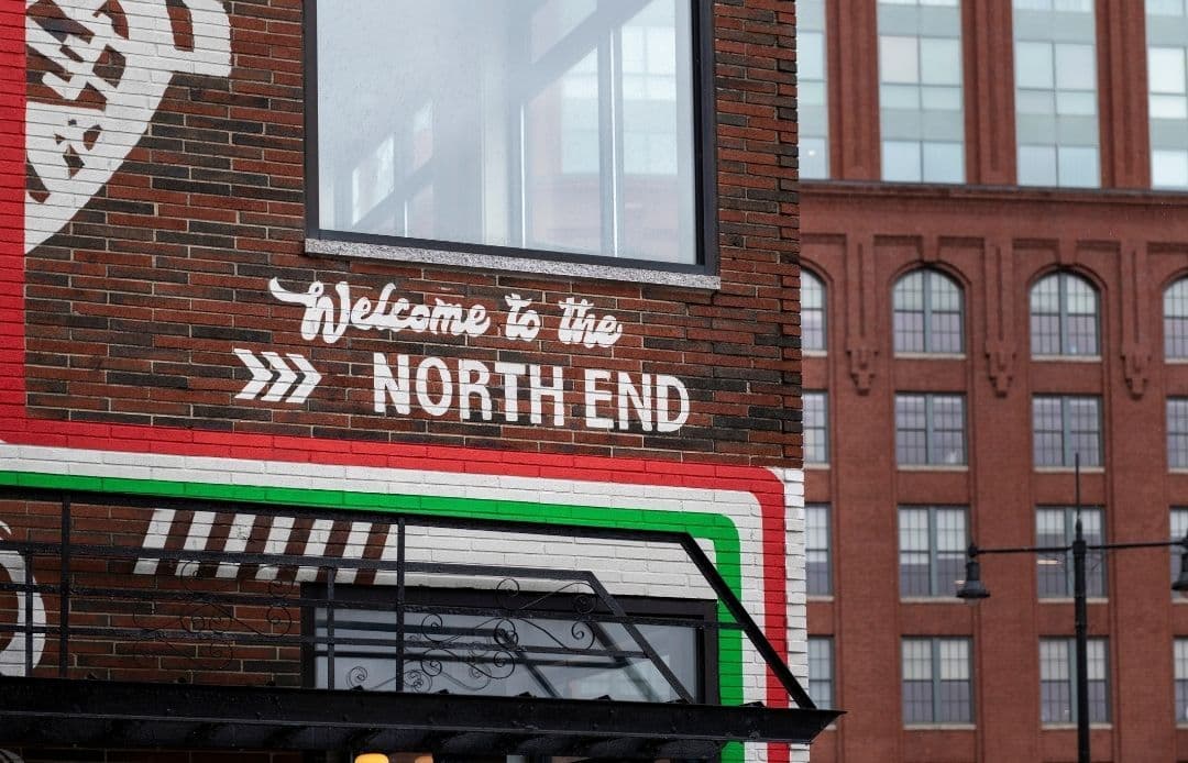 North End Boston Car Service Welcome Sign on Brick