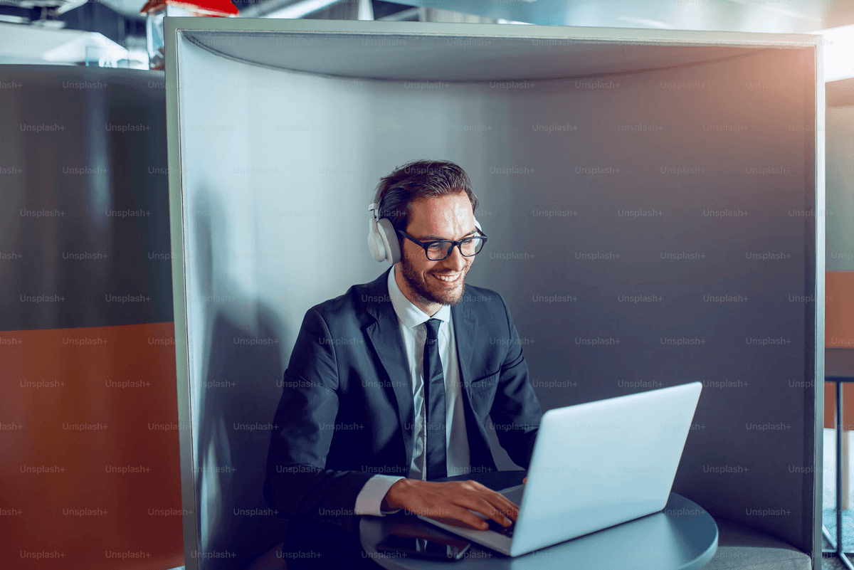Corporate travel manager working on a laptop with a headset