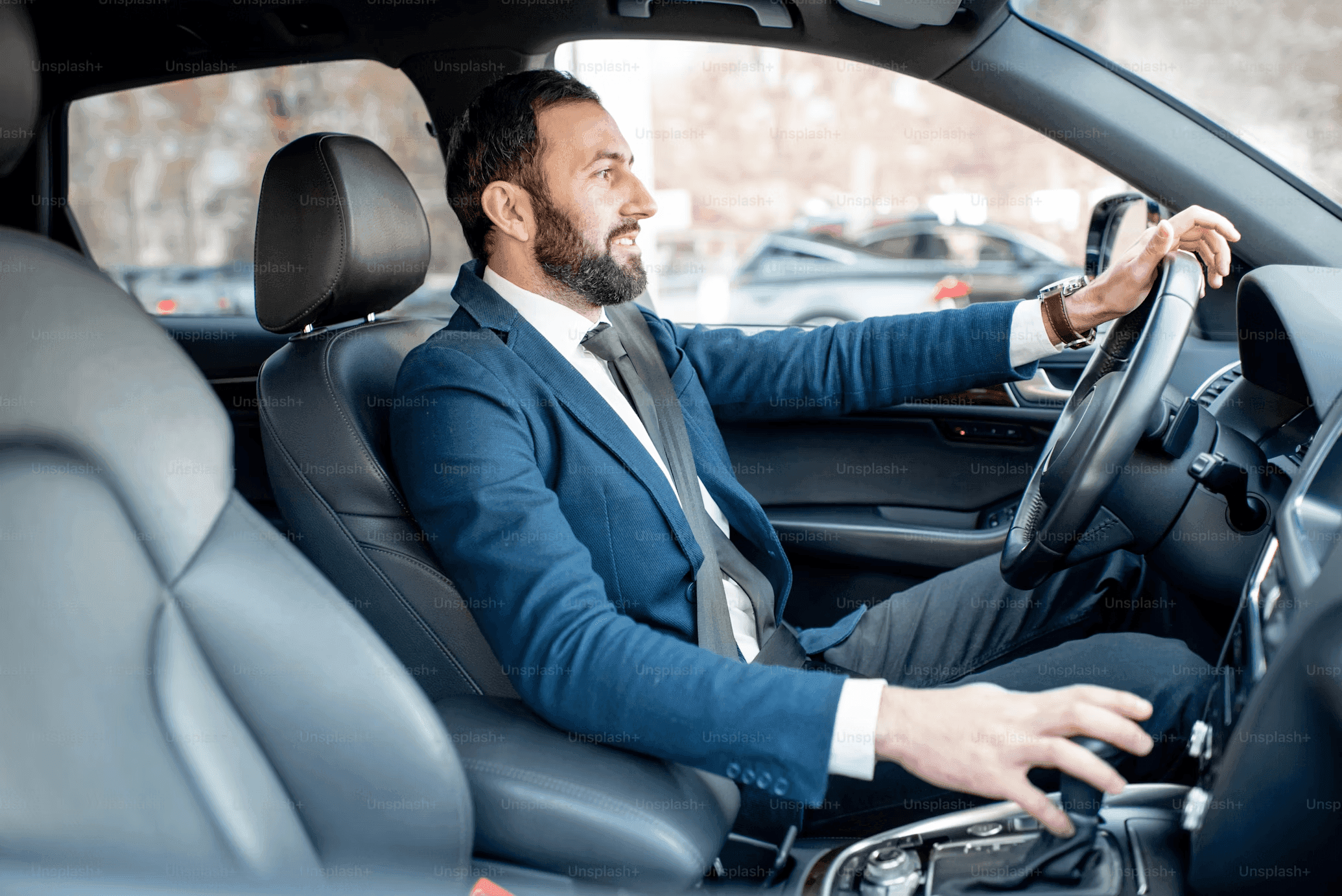 LUXY partner driver behind the wheel of a black car