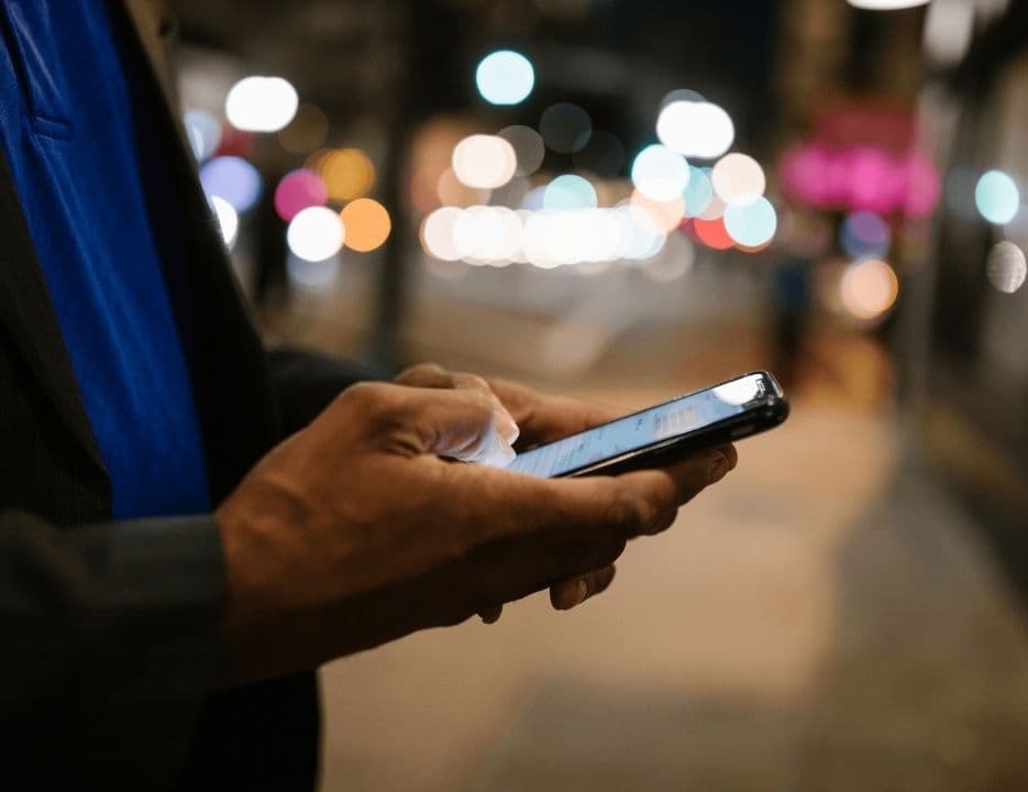 Person typing on phone close up