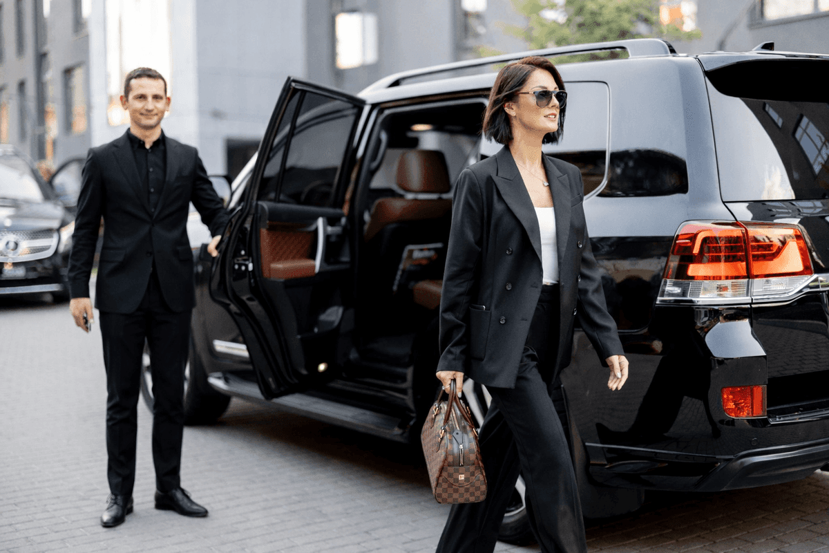 Chauffeur holding the door open for a passenger.