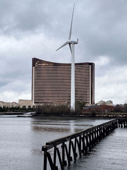 Encore Boston Harbor Car Service Distance Shot Across Water With Wind Turbine