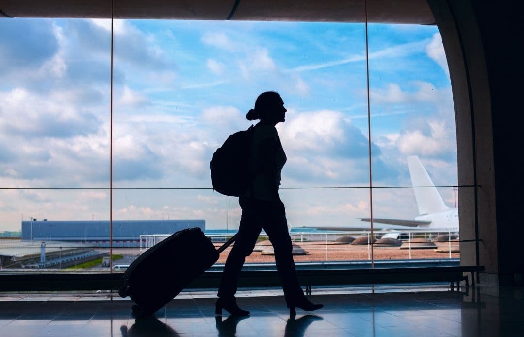 Logan Airport to Back Bay Car Service Silhouette of traveler leaving airport