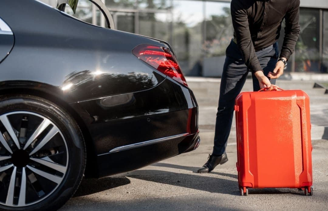 Logan Airport to Fenway Car Service Chauffeur loading suitcase into car