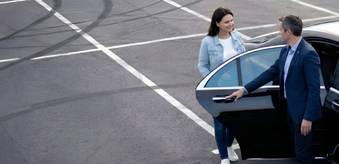 Woman getting into a black car transfer
