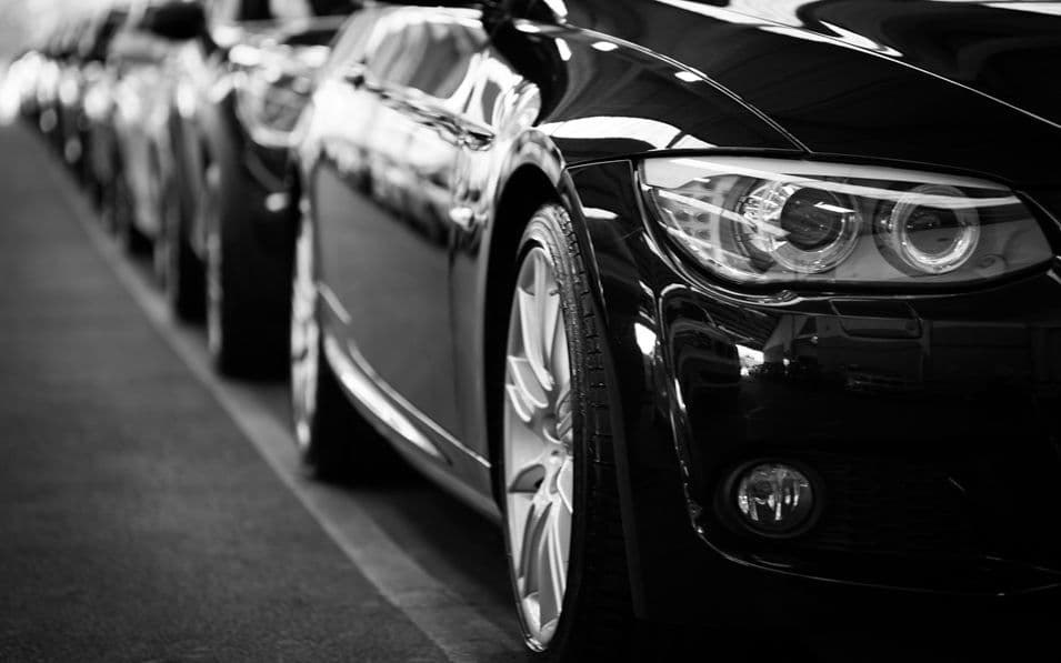 Black cars lined up on street