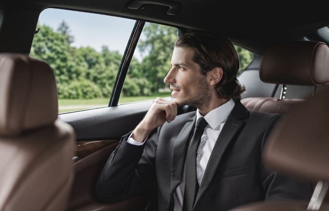 handsome man in back of car
