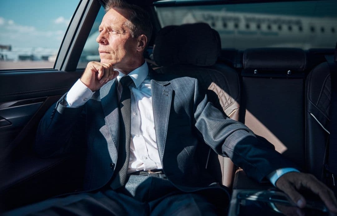 man in back of car