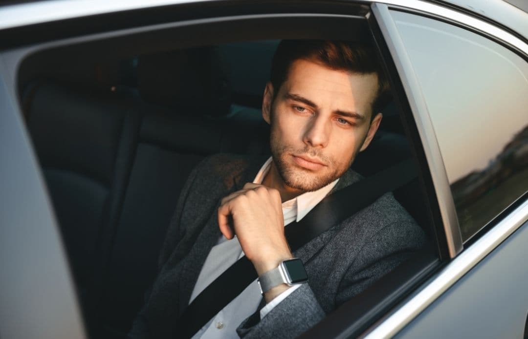 man looking out window