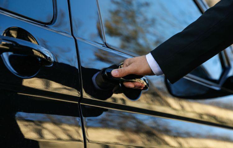 A Chauffeur's hand on a car door