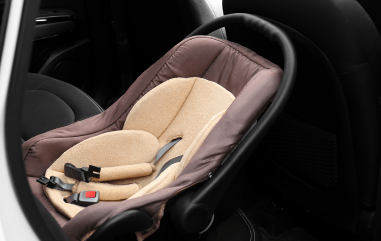 A infant seat in the back of the car