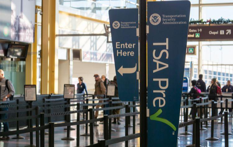 A sign for the start of the TSA security line at the airport
