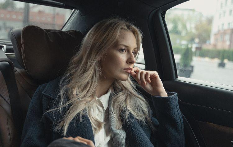 A woman looking out the window in the car