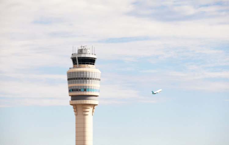 Atlanta's Hartsfield-Jackson Airport Control Tower with Plane Taking Off