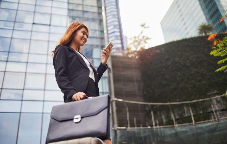 Businesswoman checking her phone while traveling