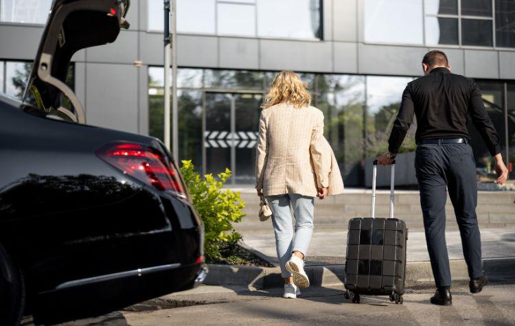 Chauffeur helping a passenger out with their luggage