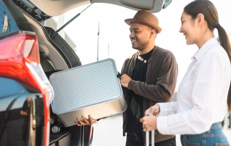 Family loading a car with luggage