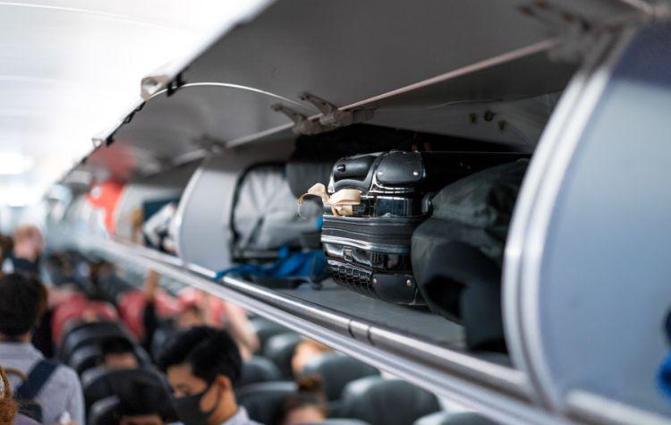 Luggage in the overhead bin on a plane