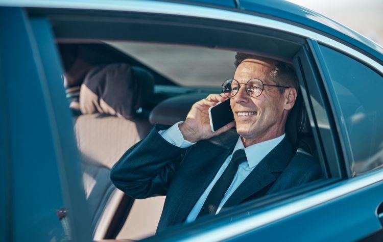 Man talking on the phone in back of car