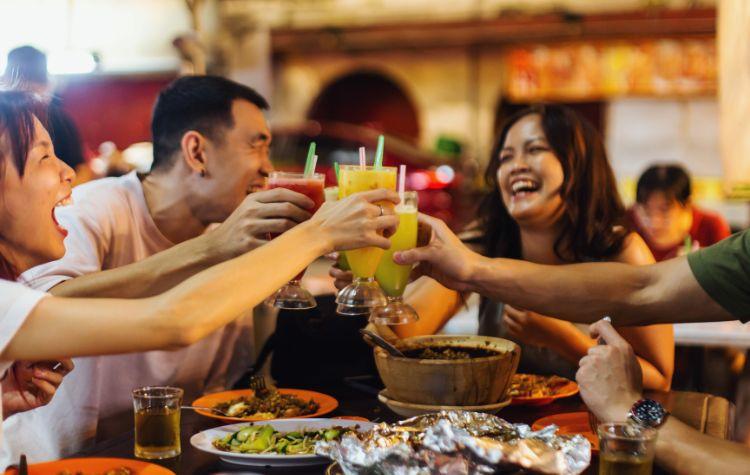 People toasting drinks at a restaurant