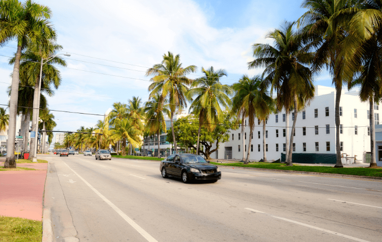 A black car driving on the streets