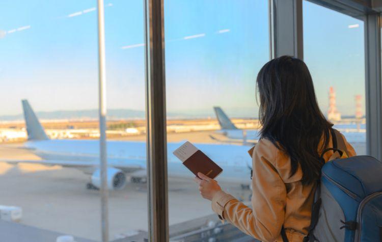 Woman looking out towards her plane in the airport