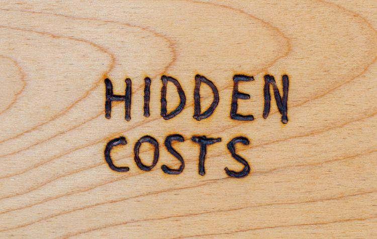 hidden costs burned into a wooden table